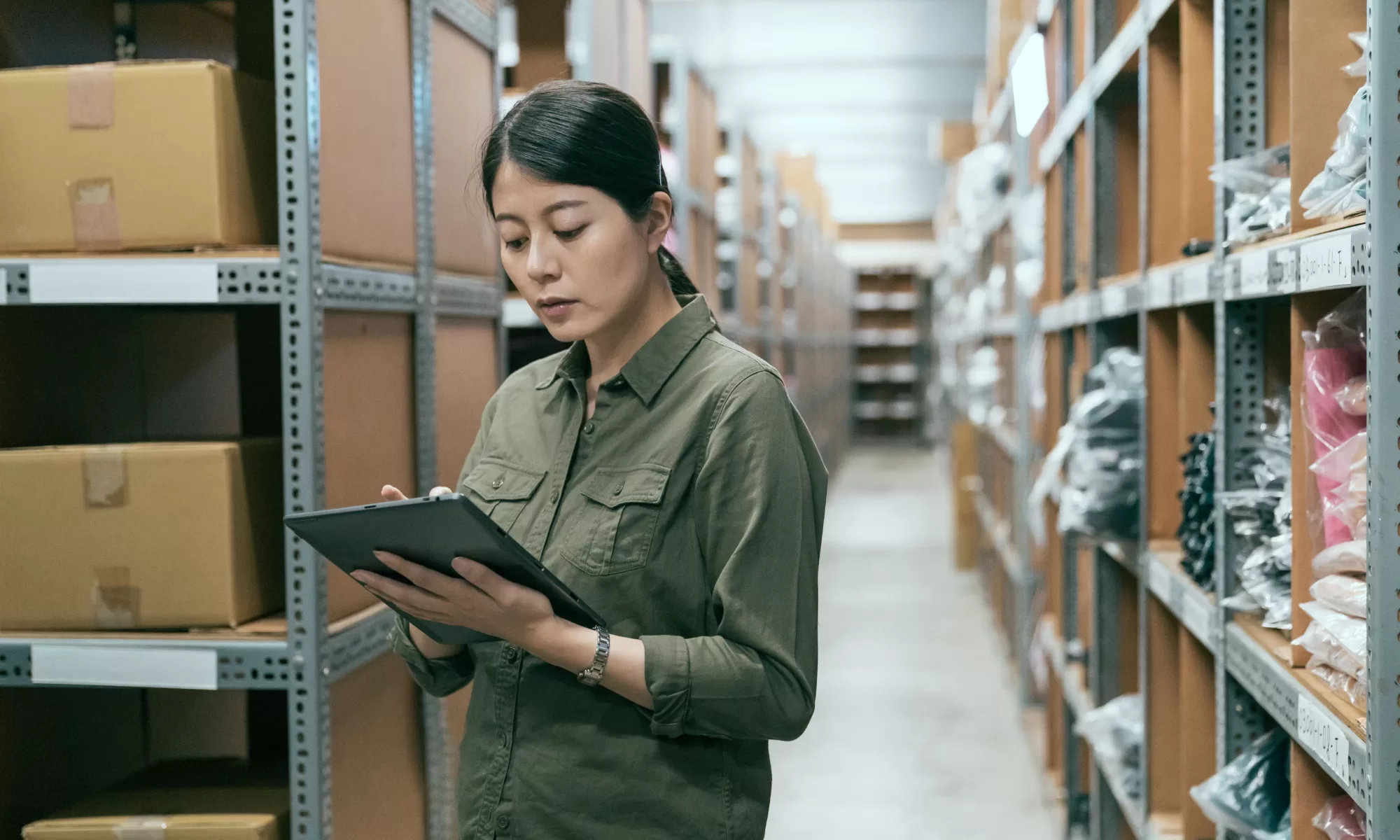 Young woman working on inventory management in a warehouse.