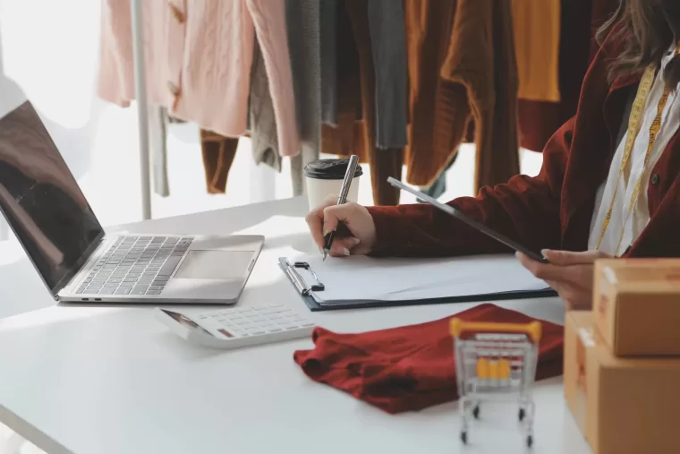 Young woman at home preparing a parcel delivery