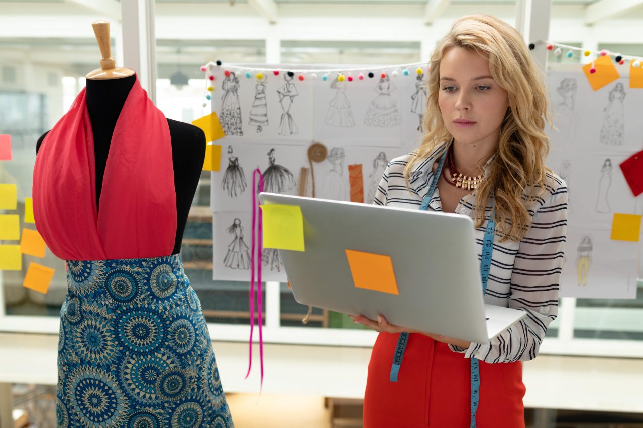 Fashion designer using laptop to design