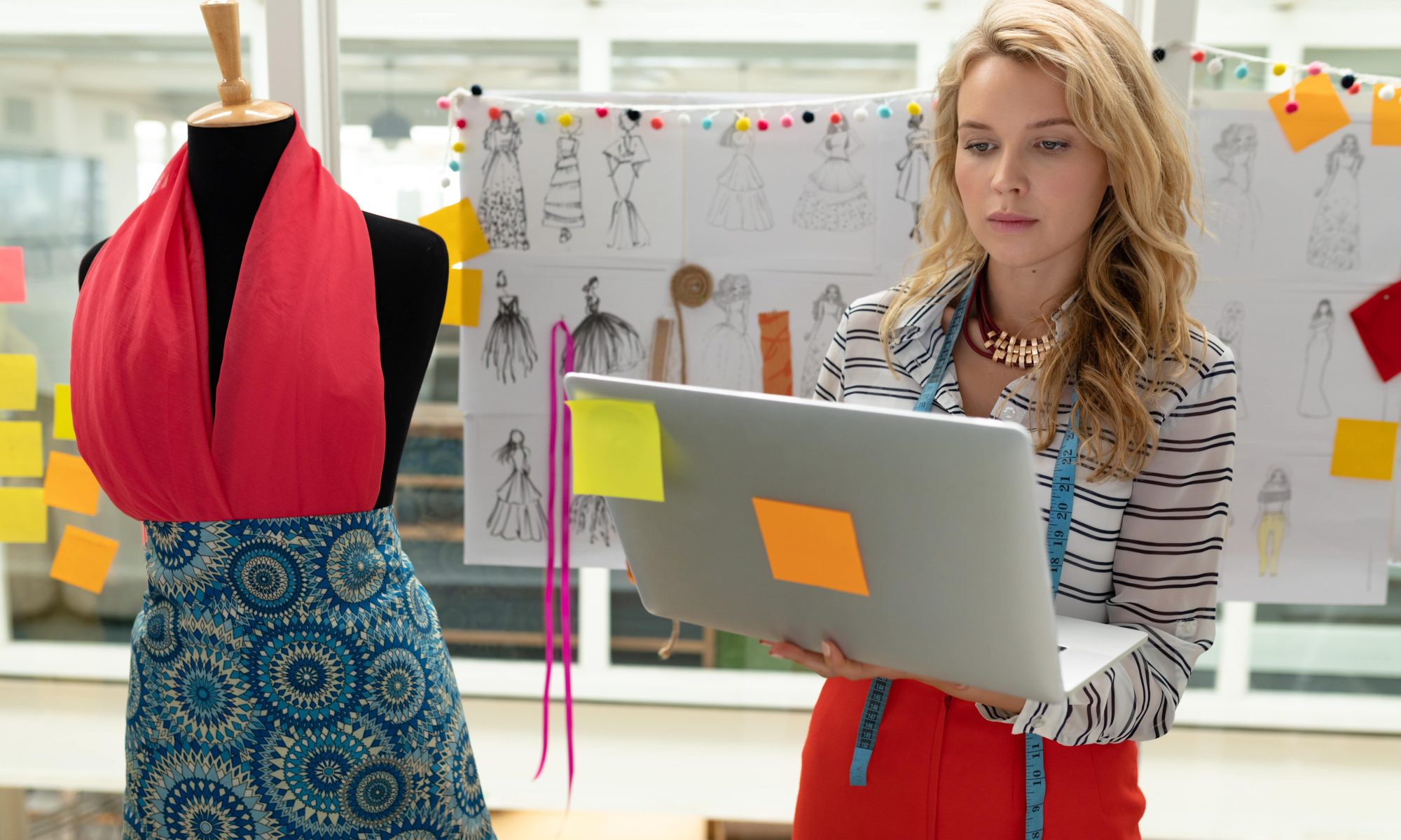 Fashion designer using laptop to design