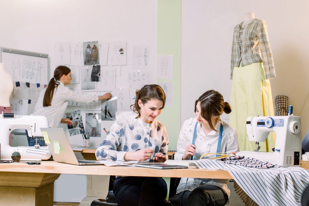 Team of fashion designers working with a laptop